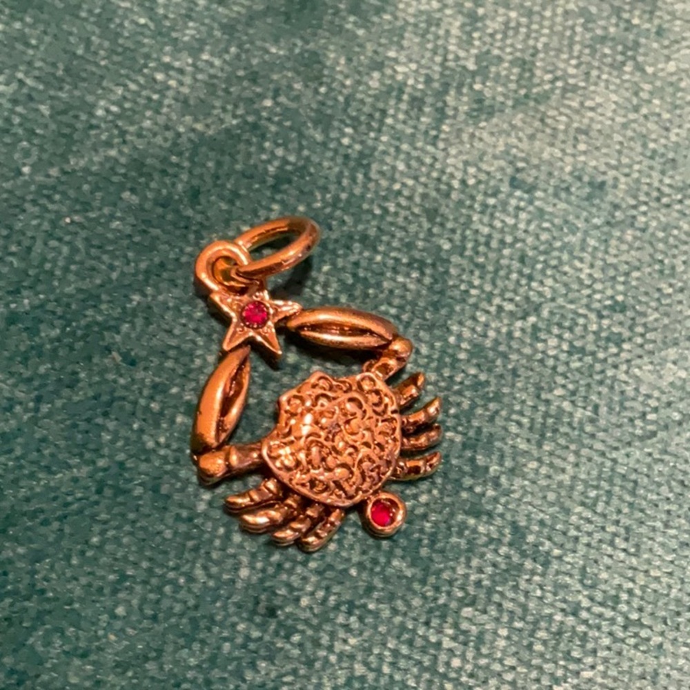 Cancer charm gold tone with two red stones